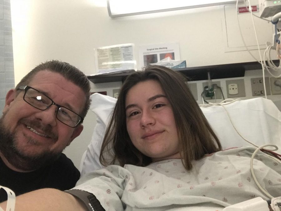 Daigle and her father pose for a picture while in the hospital.