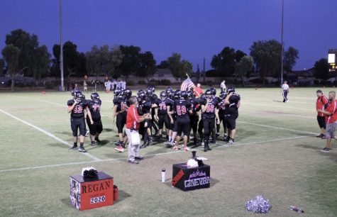 Varsity Football coming together to discuss their plays