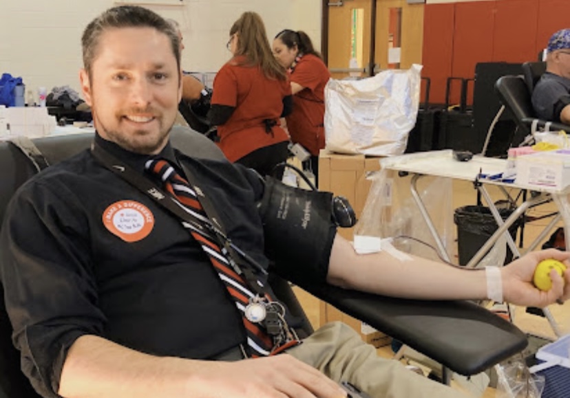 Mr. McComb getting his blood drawn at a previous blood drive.